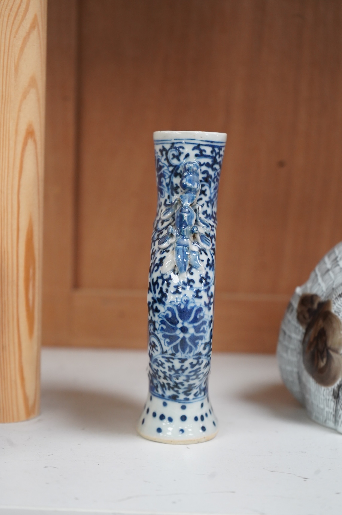 A 19th century Chinese blue and white small moon flask together with a later jar and a Portugese porcelain copy of a Chinese export cat, largest 19cm high